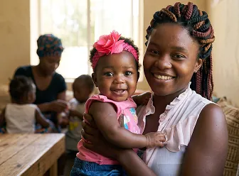 Adult holding a smiling baby