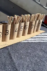 Numbered containers with wooden counting sticks