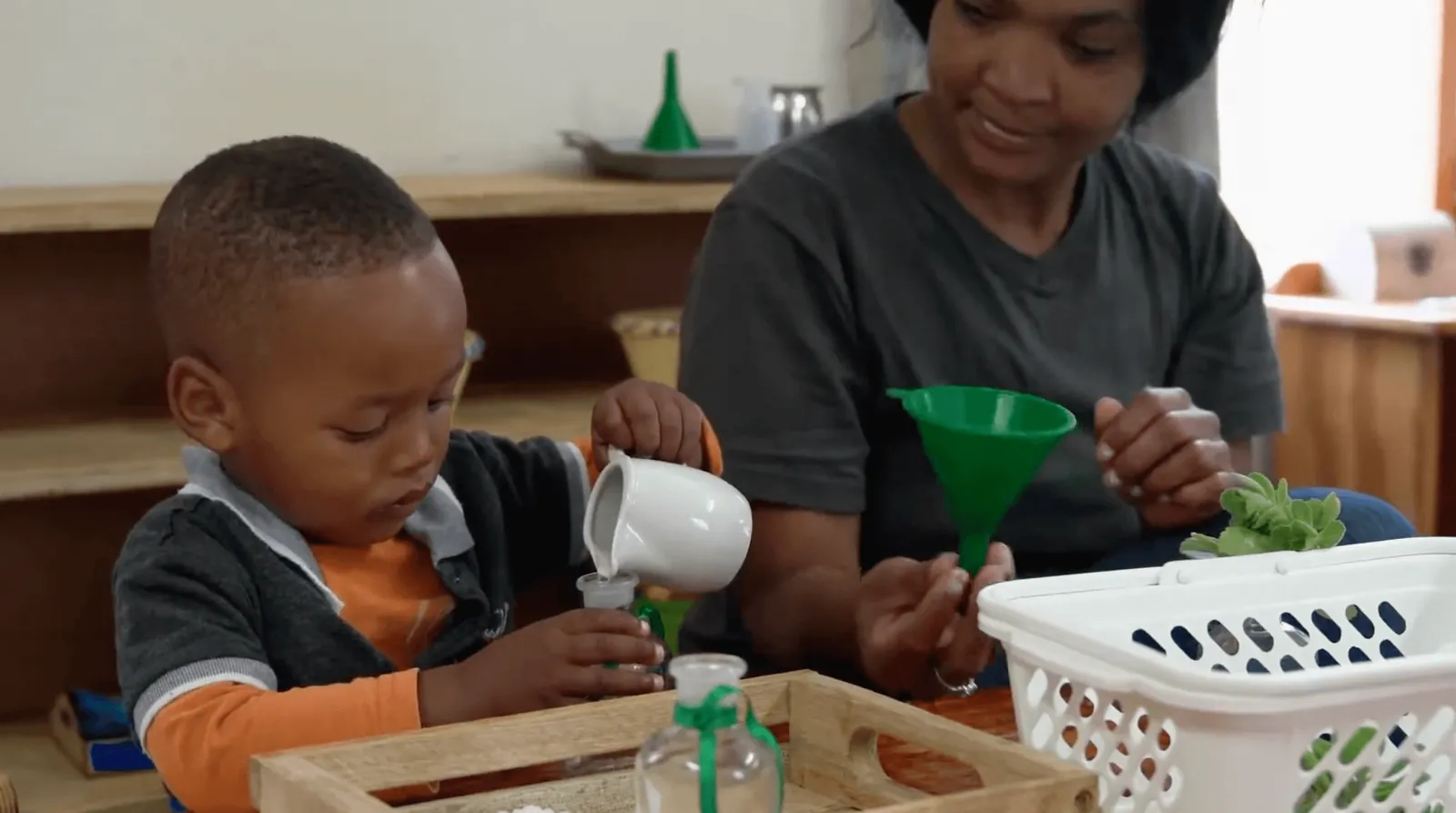 Adult and child using practical activity materials