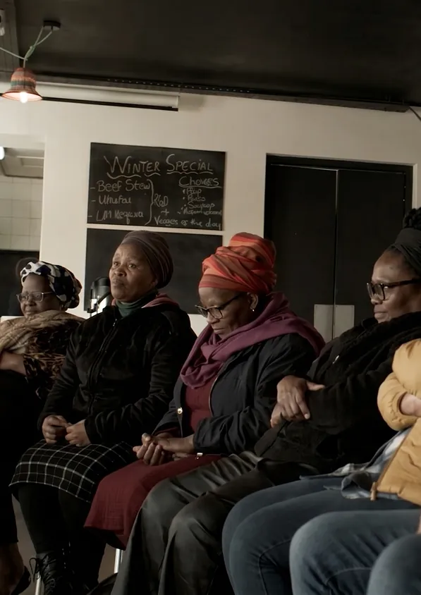 Adults gathered in an indoor learning session